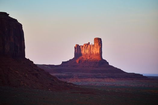 Sunset Monument Valley with large dark red rocks