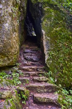 Stair stone steps up into rock tunnel