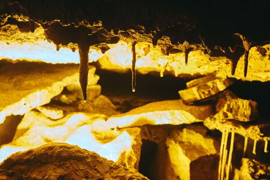 Close up detail of cave formation stalactites with water on tips forming
