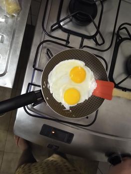 fried eggs in a kitchen pan