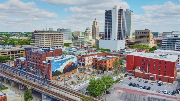 Fort Wayne, Indiana (USA) downtown city skyline with train tracks and bison mural
