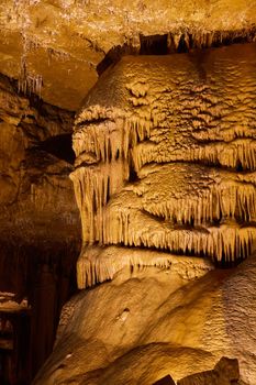 Large cave vertical detail of rock formations stalagmites and stalactites