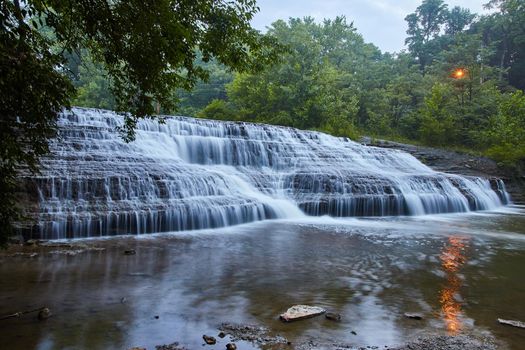 Large cascading waterfalls in midwest with green forest