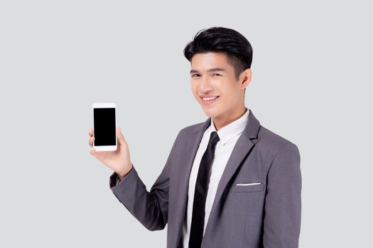 Portrait young asian business man showing and presenting smartphone with blank with success isolated on white background, businessman standing and holding phone, communication concept.
