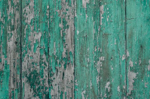 Close-up of old wooden boards with peeling paint. Textured surface. Background