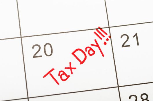 Tax Day written on a calendar to remind you and important appointment.