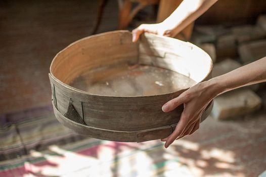 Old sieves from history museum, tool for bakery from the past for flour sifting in female hands