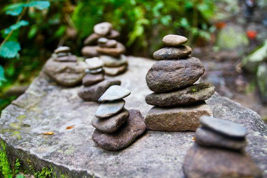 Perfectly stacked rock statues on top of another rock