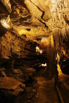 Large cave path with rock formations underground midwest america stalagmites and stalactites