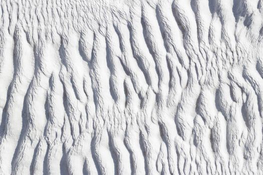 Ribbed abstract texture of Pamukkale calcium travertine in Turkey.