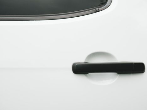 Black car door handle on white background. Automobile and texture concept. Automotive industry and safety lock and remote key accessories concept. Vehicle part unlock theme