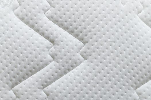Closeup of white mattress texture background. Material and furniture concept. Comfortable soft couch bedding