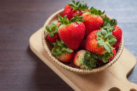 Strawberry in basket on wooden table. Fruit and vegetable concept. Freshness snack and low calories for dieting with plenty of Vitamin C