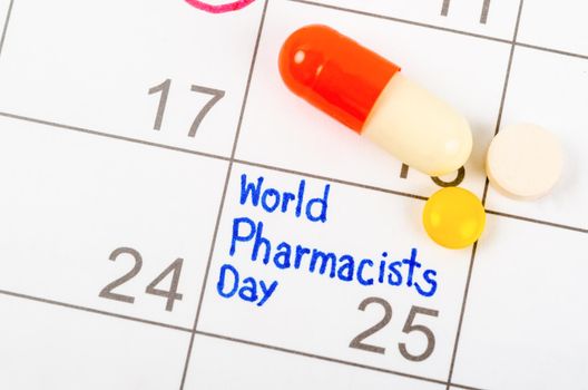 The words World Pharmacist Day written in calendar September 25 page and medicine.
