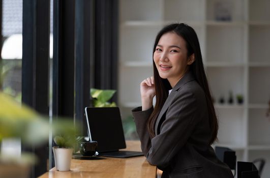 Portrait of smiling beautiful business asian woman working in modern office desk using tablet laptop computer, Business people employee freelance online marketing e-commerce telemarketing concept