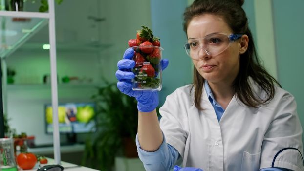Chemist typing medical botany expertise on computer for agriculture experiment