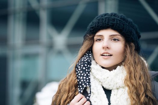 Close up portrait of young woman takes off mask standing at outdoor. Healthcare. Safety measures concept. End of pandemic. Winter outdoor curly girl. Female breathes deeply looking at camera