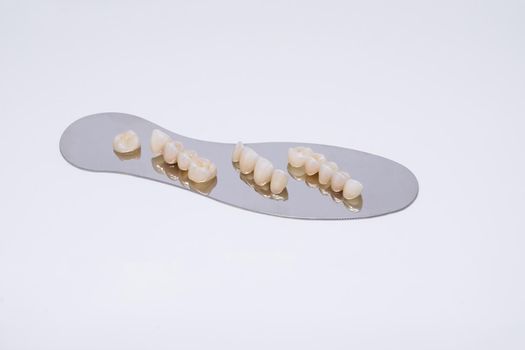 Metal free ceramic dental crowns. Zirconium tooth crown Isolate on wite background. Aesthetic restoration of tooth loss