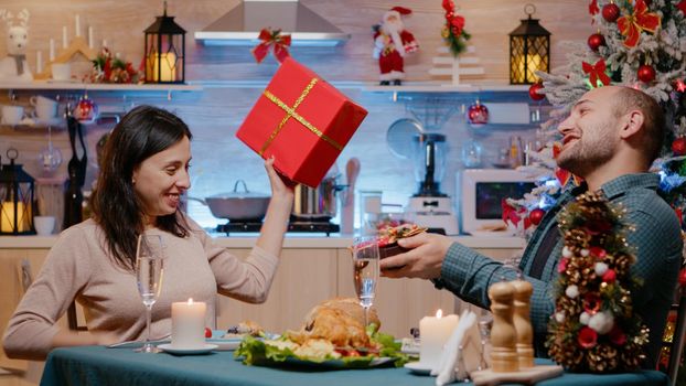 Man and woman celebrating christmas at festive dinner