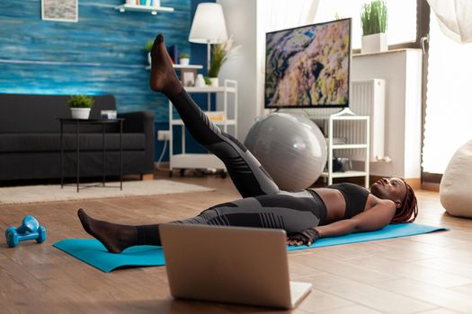 Active strong fit muscular fit woman on exercise mat doing