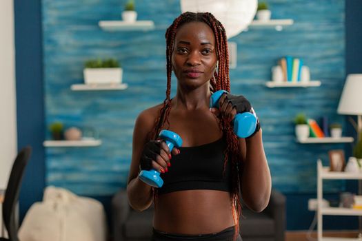 Black woman taking care of body working training arm muscles