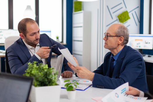 Senior entrepreneur discussing with coworker