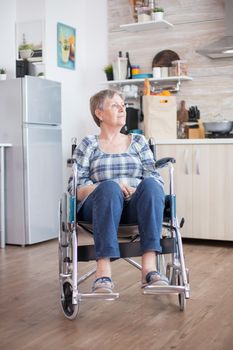 Disabled sad woman sitting in wheelchair