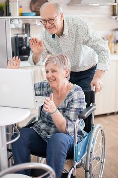 Senior couple waving during video call
