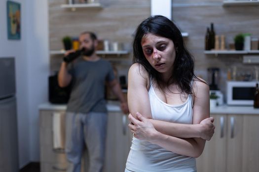 Depressed bruised woman being victim of domestic violence