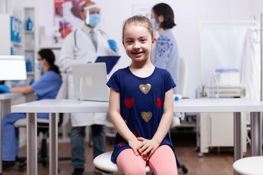 Child smiling at camera while at medical examination