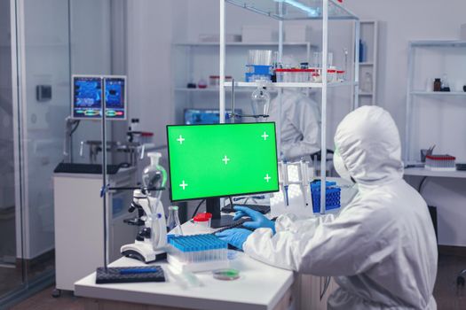 Engineer in laborator during coronavirus pandemic working on computer