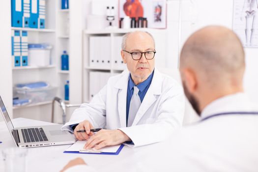 Experienced mature doctor explaining diagnosis