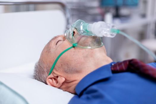 Old male patient weating oxygen mask