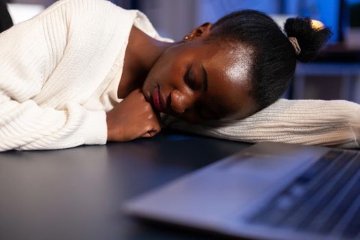 Exhausted overload african business woman falling asleep on desk