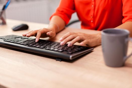 Unrecognizable businesswoman entrepreneur typing
