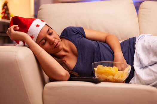 Girl falling asleep on couch in xmas decorated kitchen