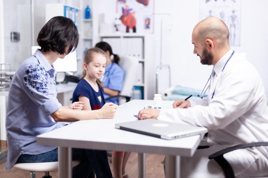 Pediatrician writing treatment