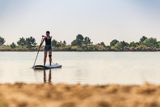 Woman stand up paddleboarding