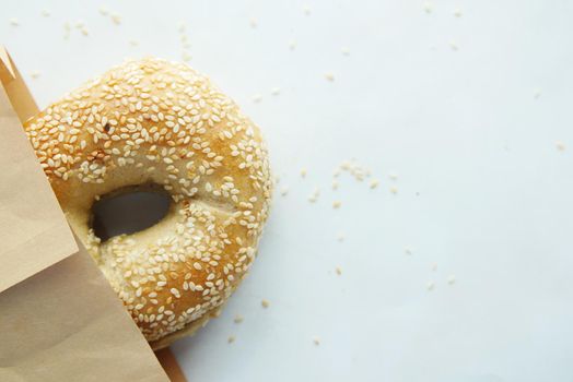 bagel and paper packet on white background