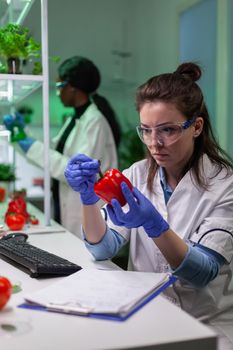 Biologist woman examining pepper writing microbiology medical expertise