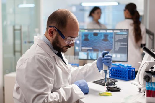Biochemistry health care scientist testing blood sample using micropipette