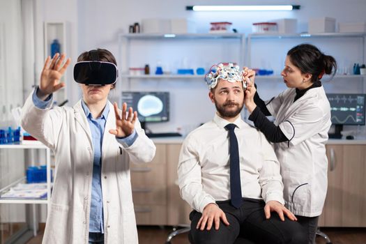 Neuroscientist developing diagnosis wearing virtual reality headset