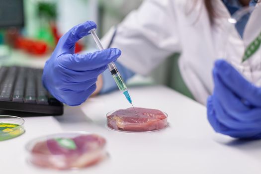 African chemist injecting at lab-grown vegan meat sample