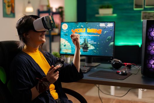 Winner player holding console playing virtual reality videogame