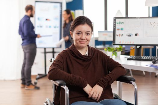 Close up of paralysed woman work colleague looking at camera smiling