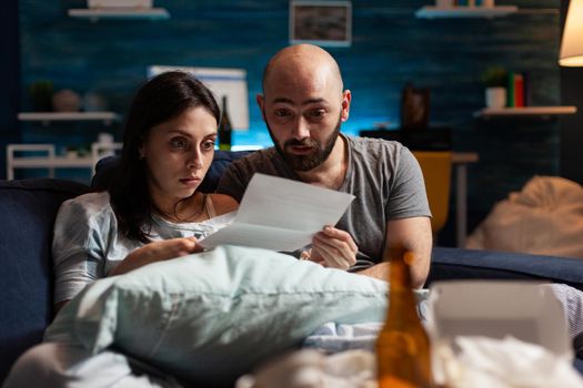 Depressed couple feeling sadness stressed about high mortgage rate