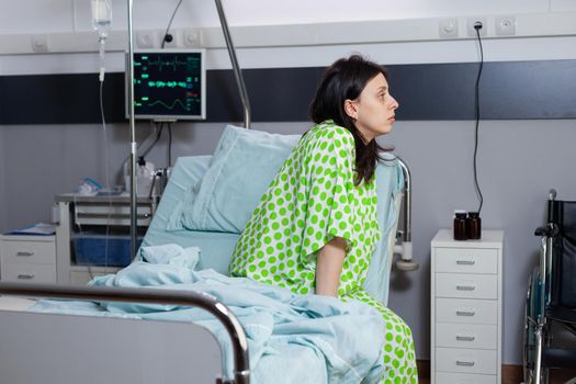 Hospitalized patient lying in bed during illness consultation