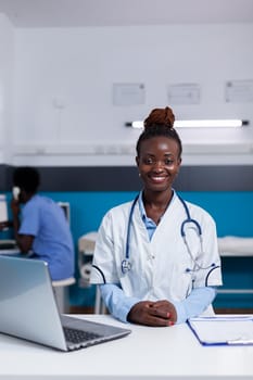 Portrait of african ethnicity doctor looking at camera