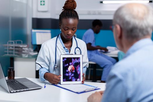 African american medic holding virus animation on tablet