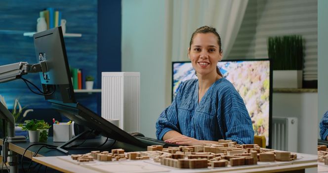 Woman working as engineer designing building model